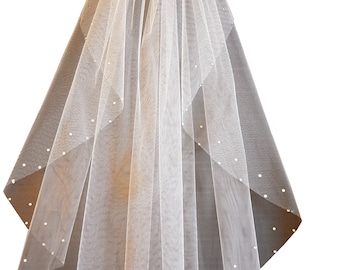 May include: A white bridal veil with a single layer of tulle and a scattered rhinestone design.