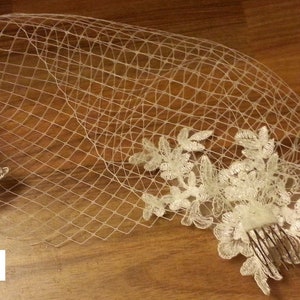 white or Ivory bridal veil with a floral lace motif