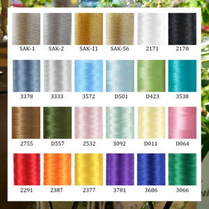 May include: A color chart of embroidery thread spools in various colors. The chart includes shades of beige, gray, gold, white, black, blue, green, pink, yellow, orange, purple, and red. Each spool is labeled with a unique code.
