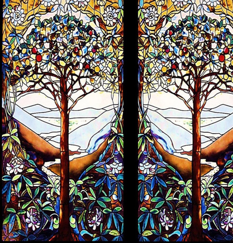 May include: Stained glass window panel featuring two trees with brown trunks and branches, laden with red and yellow fruit. The trees are set against a backdrop of mountains and a sky of white and blue. The design includes floral and leaf patterns in shades of blue, green, and white.