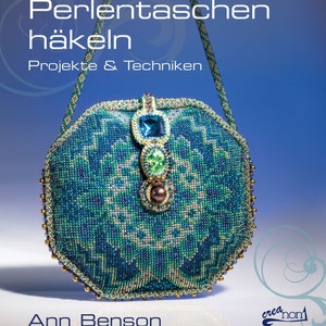 Könnte beinhalten: Eine blaue und grüne Perlenhandtasche mit einem goldenen Verschluss und einem Perlengurt. Die Tasche ist mit bunten Perlen und Edelsteinen verziert. Der Titel des Buches lautet "Perlenttaschen Häkeln Projekte & Techniken".