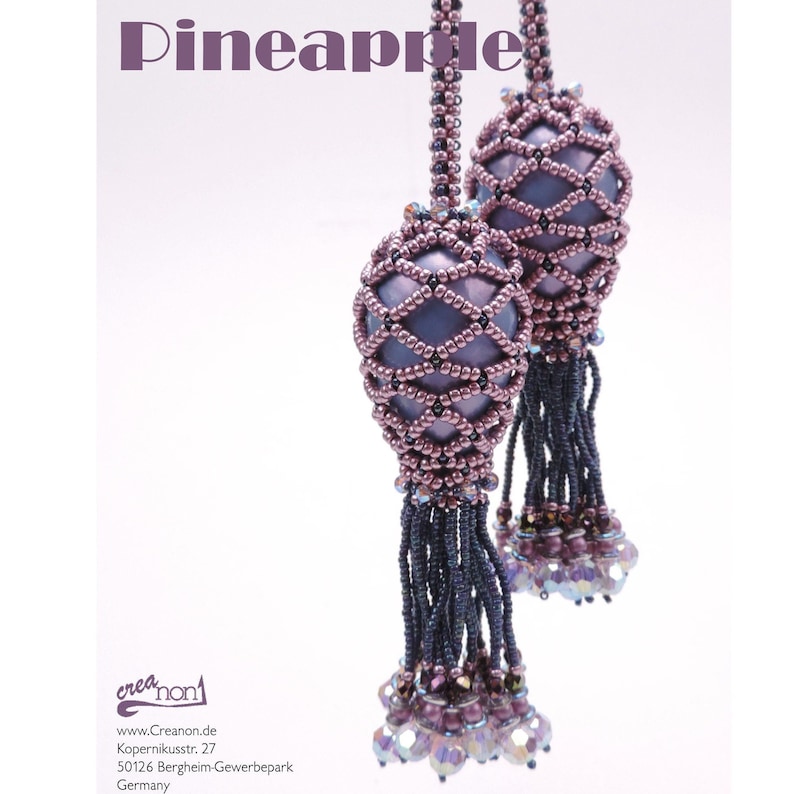 May include: Two purple and silver beaded pineapple-shaped ornaments with tassels hanging from them. The ornaments are made with small beads and have a geometric pattern.