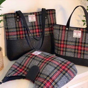 May include: Three gray and red plaid tote bags with black leather handles and black bottoms. The bags have a label that says "Harris Tweed" on them.