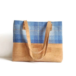 May include: A blue and white plaid tote bag with cork bottom and leather straps. The bag has a label that reads "Mr. Charles Hower Handmade in Scotland".