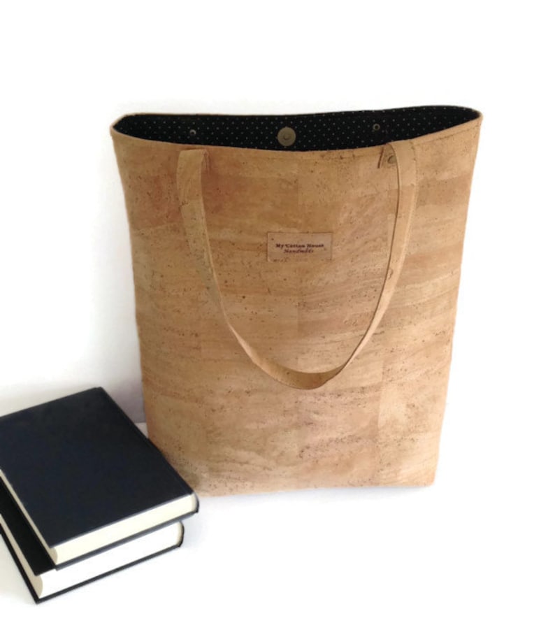 May include: A cork tote bag with black polka dot lining and a brown leather label that says "My Cotton House Handmade".