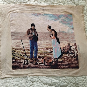 May include: A tapestry depicting two figures in a field, one holding a rake and the other pushing a wheelbarrow. The tapestry is framed with a beige border and has the text "TAPISSERIE CRO" at the top.