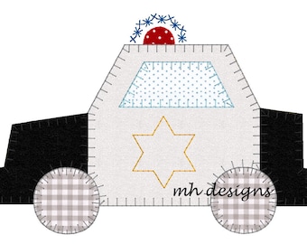 May include: A white and black felt applique of a police car with a blue and red light on top, a yellow six-pointed star, and the text "mh designs".