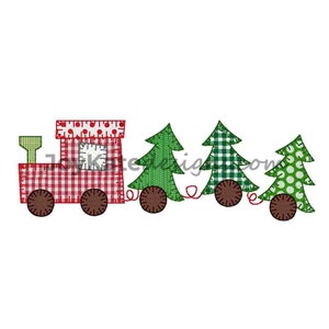 May include: A red toy train with a green chimney pulls three Christmas trees. The trees are decorated with green, white, and red fabric.