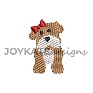 May include: Embroidered design of a brown dog with a red bow. The dog is standing with its front paws together and its back paws slightly apart. The dog has a white muzzle and black eyes.