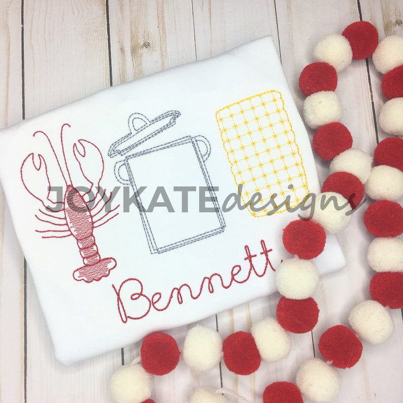 May include: A white t-shirt with a red embroidered lobster, a gray pot with a lid, and a yellow checkered design. The name "Bennett" is embroidered in red below the design.