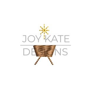 May include: A gold star with a brown manger underneath. The text "JOY KATE DESIGNS" is above the manger.