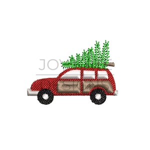 May include: A red station wagon with wood paneling is carrying a green Christmas tree on top.