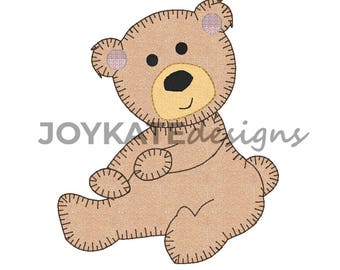 May include: A brown teddy bear with pink ears and a yellow nose. The bear is sitting with its legs crossed and its arms folded.