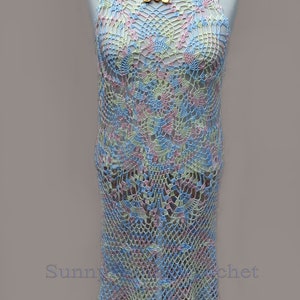 May include: A crocheted dress in a light blue, pink, and yellow color scheme. The dress has a delicate floral pattern and a scalloped hem.