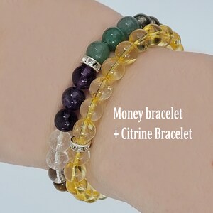 May include: Two beaded bracelets. One bracelet features a mix of purple, green, and clear beads with a silver spacer. The other bracelet is made of yellow citrine beads. Text on the image reads "Money bracelet + Citrine Bracelet."