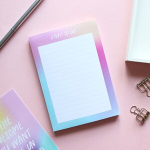 May include: A pastel pink, blue and purple gradient notepad with the text "Stuff to do" at the top. The notepad has lined paper and is perfect for writing down tasks and ideas.