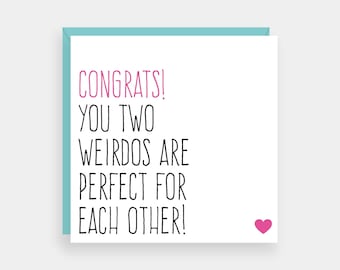 May include: A white card with a pink heart in the bottom right corner. The card has black text that reads "CONGRATS! YOU TWO WEIRDOS ARE PERFECT FOR EACH OTHER!"