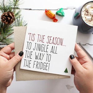 Funny Christmas greeting card that reads tis the season to jingle all the way to the fridge with a kraft envelope.