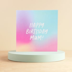 May include: A holographic birthday card with the text "Happy Birthday Mum!" in white lettering.