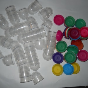 May include: A large group of clear plastic containers with lids, some stacked, and a collection of colorful plastic lids in various shades of red, green, blue, yellow, and purple.