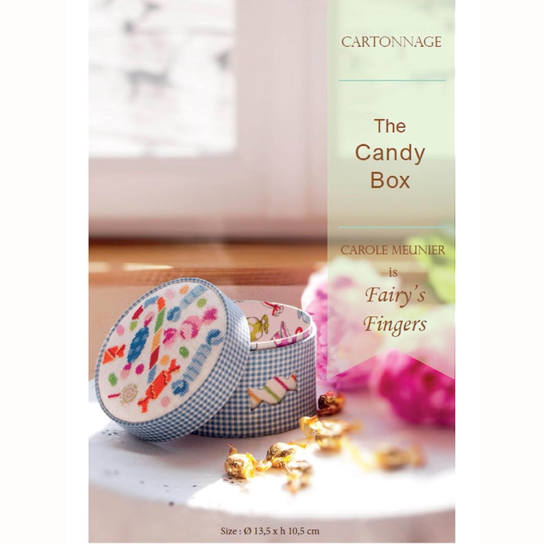 May include: A blue and white gingham candy box with a colorful embroidered design of candy on the lid. The box is open and the inside is lined with a white and blue gingham pattern. The text on the front of the box reads 'The Candy Box' and 'CAROLE MEUNIER is Fairy's Fingers'. The text at the bottom of the image reads 'Size: 13,5 x h 10,5 cm'.  