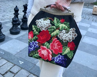 Suede handbag in a vintage style with  floral hand embroidery using an antique pattern,a metallic clasp resembling antique gold.