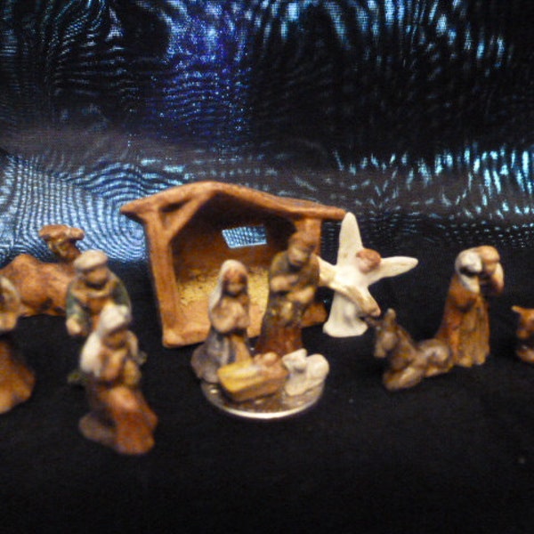 Tiny, handmade miniature thirteen piece nativity set. Mary, Joseph, Baby Jesus and the lamb can all sit on a dime. Enjoy!!