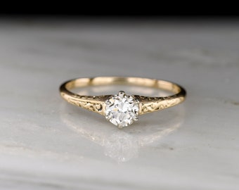 Antique Late Victorian (c. 1890s - 1900s) Petite Gold Solitaire with Ornamented Shoulders and an Early Transitional / European Cut Diamond