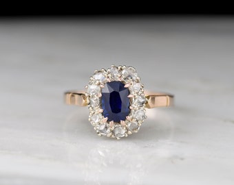 Antique Victorian (c. Late 1800s) 18K Rose Gold Cluster Ring with an Elongated Cushion Sapphire and Rose Cut Diamonds