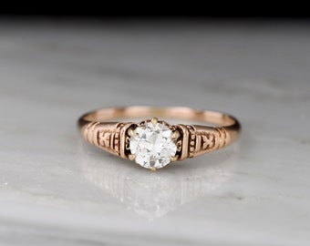 Antique Victorian (c. 1890s) Solitaire Engagement Ring with Ornamented Shoulders and a Transitional Cut Diamond Center