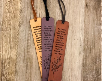 May include: Three leather bookmarks in orange, purple, and brown, each with a different coloured cord. The bookmarks feature the text "For I know the plans I have for you..." and the reference Jeremiah 29:11.