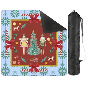May include: A Christmas-themed mat with a red center featuring a Christmas tree, a fairy, and a nutcracker. The mat has a blue border with floral and candy cane designs, and red bows. A black carrying bag is included.