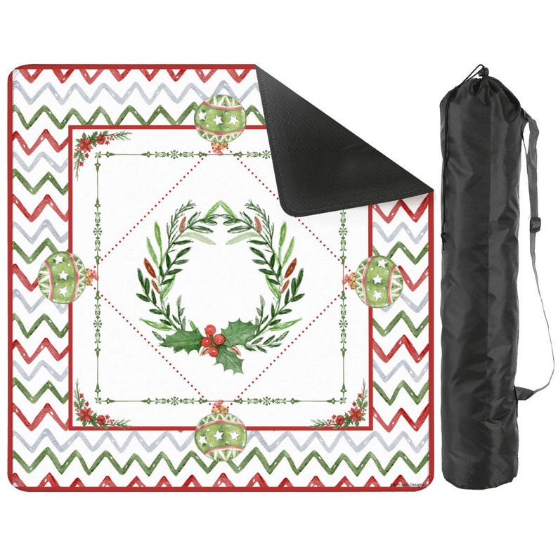 May include: A Christmas-themed picnic blanket with a white center featuring a wreath and ornaments. The border has a red and green zigzag pattern. A black carrying bag is included.