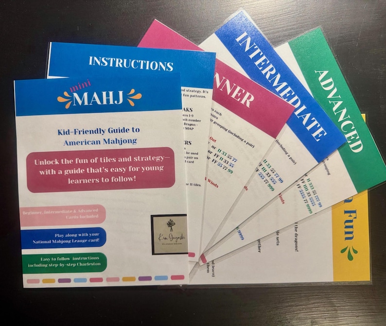 May include: A collection of colorful instruction cards for American Mahjong. The main guide, titled "mini MAHJ," is blue and white, with the text "Kid-Friendly Guide to American Mahjong." Other cards are labeled "Beginner," "Intermediate," and "Advanced."
