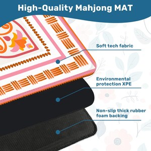 May include: A high-quality Mahjong mat with a colorful floral design in pink, orange, and white. The mat features a soft tech fabric, environmental protection XPE, and a non-slip thick rubber foam backing. The text "High-Quality Mahjong MAT" is at the top.