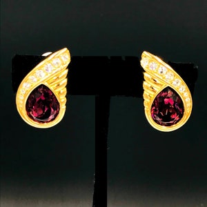 STUNNING Vintage SWAROVSKI AMYTHYST  ( Purple ) Tear drop shape Bezel Set with Clear Crystals set in gold tone.Clip Earrings.  Has Swan Logo