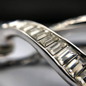 VINTAGE SWAROVSKI Clear  Crystal Baguettes Loop Clip Earrings. Has Swan Logo. Silver plated . 1980&quot;s 1 1/4 inch length.