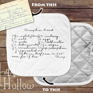 May include: White quilted pot holder with a handwritten recipe for pumpkin bread. The recipe includes ingredients like flour, nutmeg, and pumpkin. The pot holder has a loop for hanging and the text "Pumpkin bread" is visible.