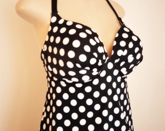 May include: Black and white polka dot halter top swimsuit.