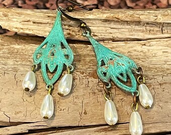 May include: Teal green filigree earrings with three white pearl drops on each earring.