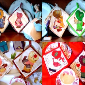 May include: Set of six colorful quilted pot holders featuring a variety of designs with children wearing hats and holding objects. The pot holders are square and have a quilted texture.