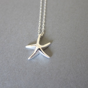 May include: A silver necklace with a starfish pendant. The starfish is a simple design with five points.