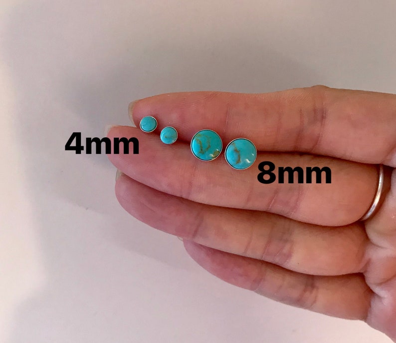 May include: A collection of turquoise stud earrings in various sizes. The earrings are round with a silver setting. The image shows earrings in 4mm and 8mm sizes. The turquoise stones have a marbled appearance.