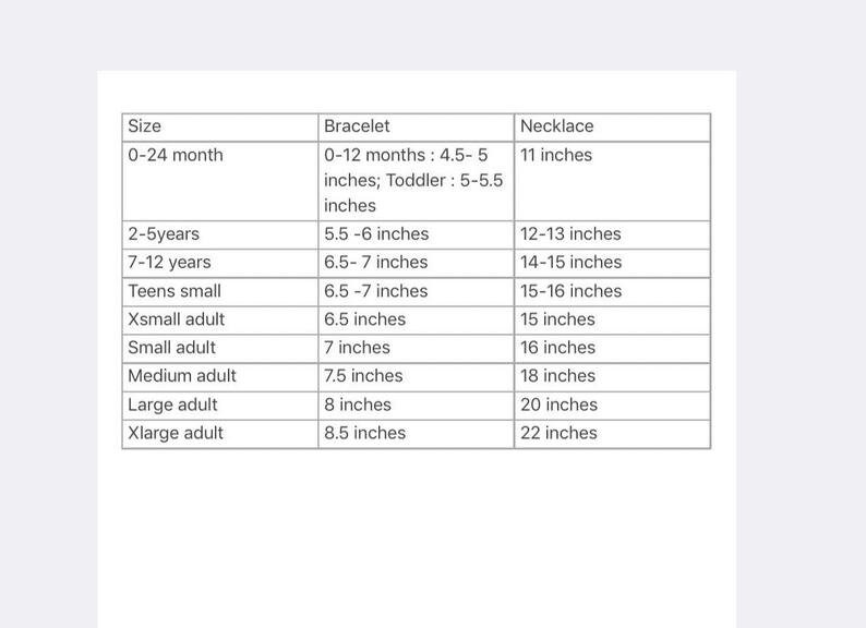 May include: A chart showing bracelet and necklace sizes for different ages and sizes. The chart includes sizes for 0-24 months, 2-5 years, 7-12 years, teens small, x-small adult, small adult, medium adult, large adult, and x-large adult. The chart shows the corresponding bracelet and necklace sizes in inches.