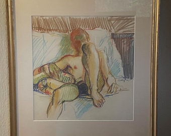 May include: Framed artwork featuring a seated figure, rendered in colored pencil. The artwork showcases a nude figure in a relaxed pose, with a palette of greens, blues, and browns. The piece is signed and framed in a gold-toned frame.
