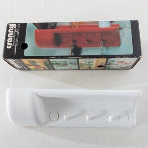 May include: A set of three ceramic mugs with a speckled, matte finish. The mugs are in shades of cream, light gray, and dark gray. Each mug has a simple, minimalist design, perfect for coffee or tea.