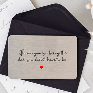 May include: Silver metal card with the text "Thank you for being the dad you didn't have to be." with a red heart.