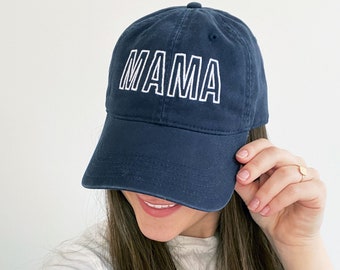 May include: A navy blue baseball cap with white embroidered text that reads "MAMA".