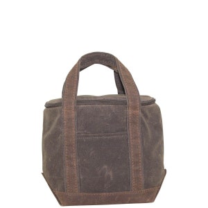 May include: A brown canvas lunch bag with a zippered top and two brown handles. The bag has a small pocket on the front.