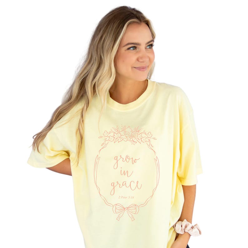 girl wearing a banana comfort colors t-shirt with custom grow in grace floral frame printed design